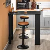 A kitchen counter with a bar table and stools, with a small oven and sink visible in the background. Produktbild-Vorschau