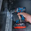 A person is using a Bosch cordless drill to screw into a metal track. Náhled obrázku produktu