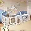 A child's bedroom with a white wooden house-shaped bed. The bed is set up as a floor bed with railings and has a stuffed animal and pillows inside. Decorative stars and a moon are on the wall. Podgląd zdjęcia produktu
