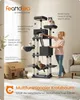 A woman is interacting with a multi-level cat tree, with several cats on and around it. A cardboard box is also visible. Produktbild-Vorschau