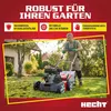 A man is using a lawnmower in a garden. Produktbild-Vorschau