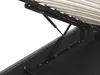 A close-up view of the internal mechanism of a bed frame, showing the gas lift struts and the wooden slats of the bed base. Podgląd zdjęcia produktu