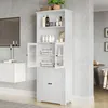 A white bathroom cabinet with glass doors and wooden doors, filled with towels and toiletries, in a modern bathroom setting. Náhled obrázku produktu