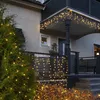 A house exterior decorated with warm white LED string lights for the holidays. Produktbild-Vorschau
