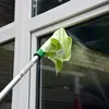 A person is cleaning a window with a cleaning tool. Produktbild-Vorschau