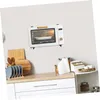 A kitchen counter with a microwave oven mounted on the wall above it. Various kitchen items are on the counter. Produktbild-Vorschau