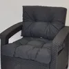 A close-up view of dark gray cushions on a dark wicker chair. Produktbild-Vorschau