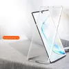A clear phone case is shown leaning against a laptop on a textured surface. Anteprima dell’immagine prodotto