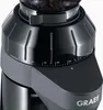 A close-up view of the top part of a black coffee grinder, showing the grind adjustment settings. Podgląd zdjęcia produktu
