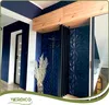 A hallway with navy blue walls and white accents, featuring a wooden shelf unit and a dark paneling wall. Podgląd zdjęcia produktu