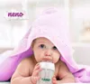A baby wrapped in a pink towel is drinking from a baby bottle. Podgląd zdjęcia produktu