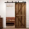 A wooden sliding door is open, revealing a living room with a leather sofa and coffee table. Produktbild-Vorschau