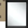 The back and front of a rectangular wall mirror with a black frame are shown against a white background. The back of the mirror shows two hanging hooks. Produktbild-Vorschau