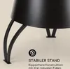 Close-up of the base of a black outdoor fireplace, showing its sturdy legs and a text overlay describing its stability. Produktbild-Vorschau