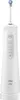A white electric water flosser with a blue-tipped nozzle sits upright on a white charging base against a white background. Náhľad obrázku produktu
