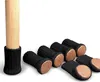 A wooden chair leg with a black knitted sock with a brown felt bottom. Produktbild-Vorschau