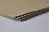 A stack of thin MDF boards on a plain surface. Produktbild-Vorschau