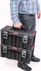 A person is carrying two stacked toolboxes. Náhled obrázku produktu
