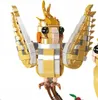 A close-up of a gold and white toy bird, likely a model kit. Náhľad obrázku produktu