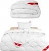 A folded duvet and a made-up bed with a duvet and pillow. Produktbild-Vorschau