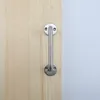 A close-up of a silver metal handle attached to a wooden surface. Anteprima dell’immagine prodotto