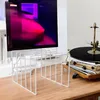 A white metal record holder stands on a wooden desk in front of a monitor displaying abstract art. A turntable with a vinyl record is visible to the right. Anteprima dell’immagine prodotto