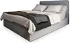 A bed with bedding and a throw blanket, shown from a diagonal angle against a white background. Produktbild-Vorschau
