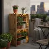 A balcony decorated with plants and lights, with a city view in the background. Náhled obrázku produktu