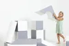 A young girl is playing with soft foam blocks, building a structure. Produktbild-Vorschau