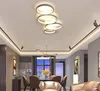 A modern living room or dining room with a ceiling light fixture, dining table and chairs, and a sofa. Produktbild-Vorschau