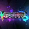 A gaming keyboard with neon graffiti-style paint splatters in the background. Anteprima dell’immagine prodotto