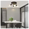 A dining room with a table, chairs, and a ceiling light. Produktbild-Vorschau