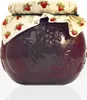 A jar of strawberry jam with a decorative lid and embossed fruit design on the glass. Voir les images du produit