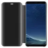 A black flip case for a smartphone is shown open, revealing the phone's screen displaying a starry night sky and a mountainous landscape. Náhľad obrázku produktu