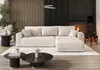 A modern living room with a sectional sofa, coffee tables, and a fireplace. Voir les images du produit
