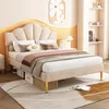 A bedroom scene featuring a beige upholstered bed with a shell-shaped headboard. Náhled obrázku produktu