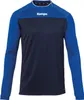 A long-sleeved shirt with a blue upper chest and sleeves, and a dark blue lower chest and torso. The brand name 'Kempa' is visible in white on the upper chest. Voir les images du produit