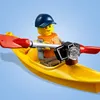A LEGO minifigure in a yellow kayak with a paddle and a camera. Produktbild-Vorschau