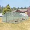 A large chicken coop with a metal frame and mesh walls is set up in a grassy yard in front of a house. Náhled obrázku produktu