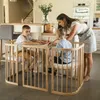 A mother is supervising her two young sons as they draw at a table in a modern kitchen. Produktbild-Vorschau