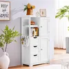 A white storage cabinet with shelves, drawers, and doors, decorated with a vase of flowers, a framed picture, and a clock on top. A plant is visible to the right. Produktbild-Vorschau