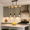 A kitchen scene featuring a pendant light fixture over a countertop with a stove and cabinets in the background. Produktbild-Vorschau