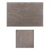 Two bath mats, one rectangular and one square, are shown against a white background. Produktbild-Vorschau