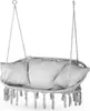 A white hanging chair with pillows and fringe detail, suspended by ropes. Voir les images du produit