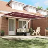 A burgundy retractable awning is installed over a patio area with outdoor furniture. Produktbild-Vorschau