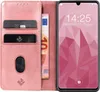 A pink flip case for a smartphone, with credit cards and a banknote inserted. Produktbild-Vorschau