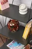 A shelf with books and decorative items. Náhled obrázku produktu