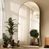 A full-length arched mirror is placed in a room with plants and curtains. Anteprima dell’immagine prodotto