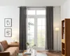 A living room scene with curtains, a sofa, a bookshelf, and a coffee table. Produktbild-Vorschau
