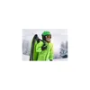 A child wearing a green ski jacket and helmet, carrying a green sled over their shoulder in a snowy environment. Podgląd zdjęcia produktu